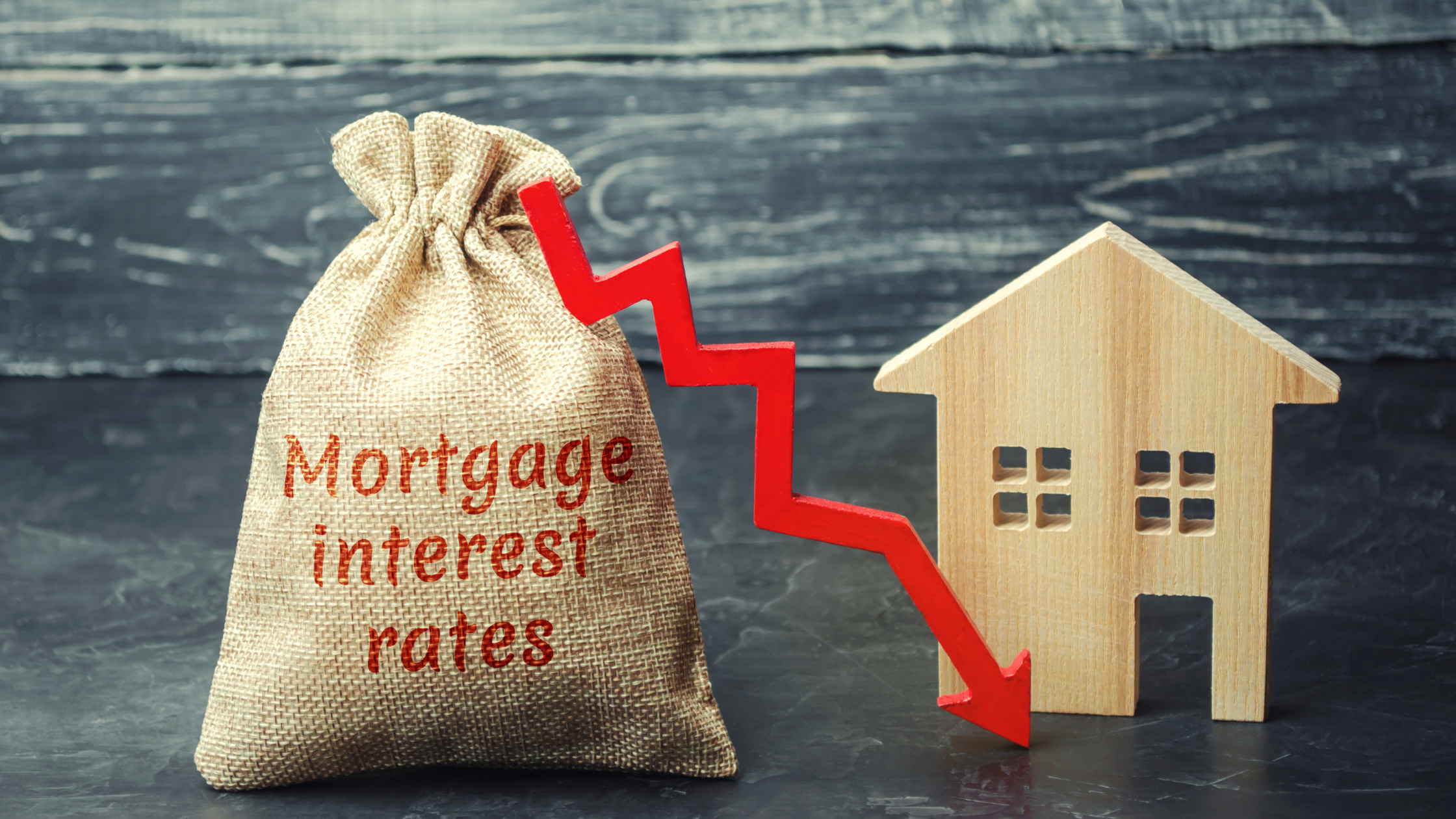 A sack and home representing the concept of high interest in property due to low-interest rates.