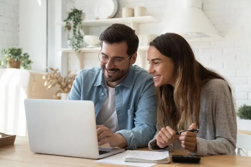 Happily smiling couple secures financial freedom with strategic financial planning.