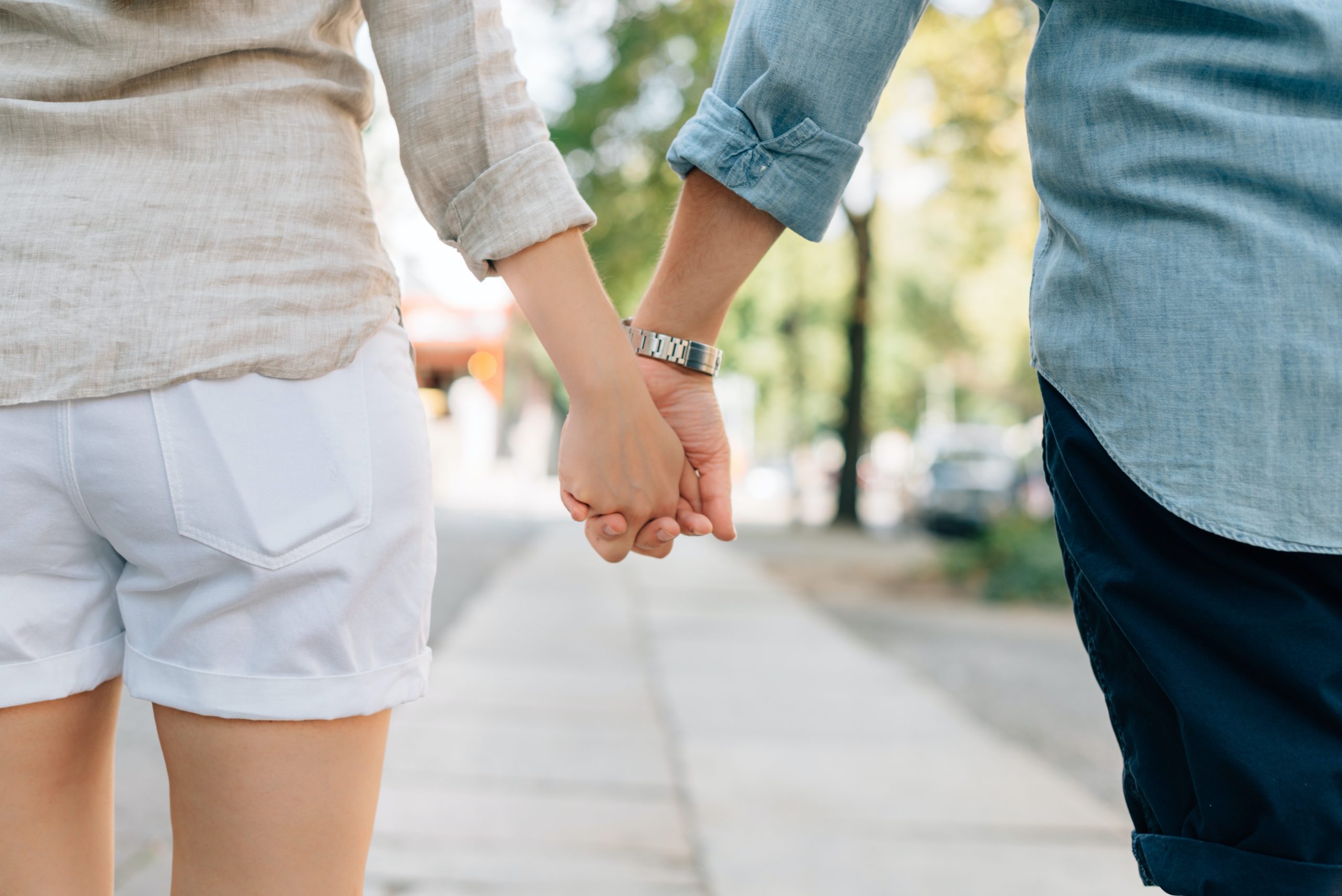 A financially compatible couple holding hands, symbolising financial security and stability.