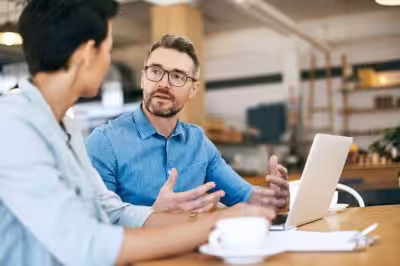 Two people discussing an investment opportunity