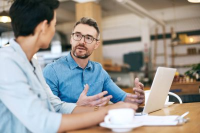 Two people discussing an investment opportunity