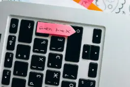 Keyboard with tax law sticky notes.