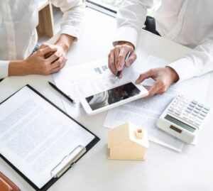 Business meeting with documents, tablet, and calculator.