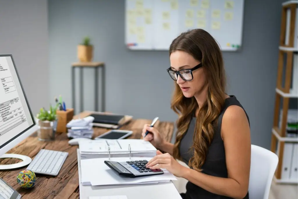 Woman working on business accounting in office.