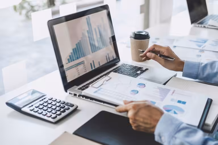Person analysing financial graphs with expert financial planning, budgeting and wealth management guidance.