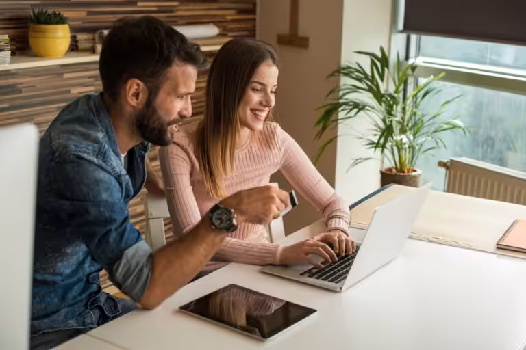 Couple comparing online purchases while creating a smarter budget with a financial planner Penrith.