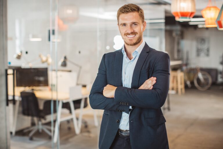 Smiling professional in modern office setting.