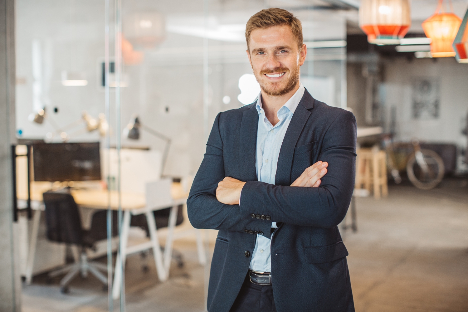 Smiling professional in modern office setting.