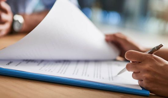 Person confidently signing a document of Employment Practices Liability Insurance.