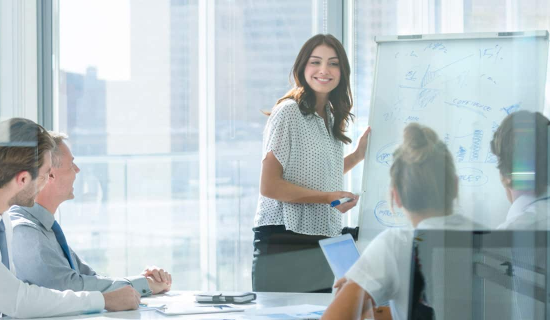 A knowledgeable woman leading an engaging session, highlighting the importance of Management Liability Insurance.