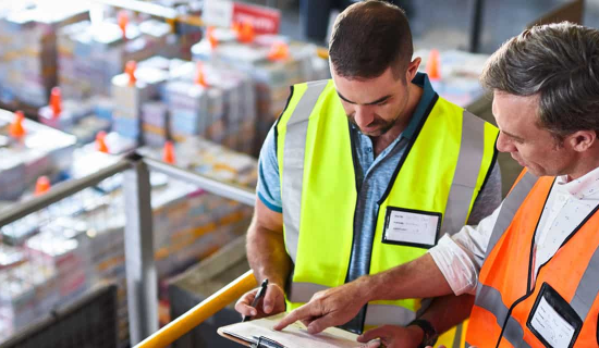 A man educating a worker about worker compensation insurance.